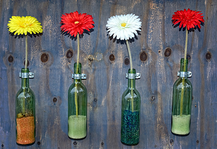 glass bottle repurposed into a planter or a vase