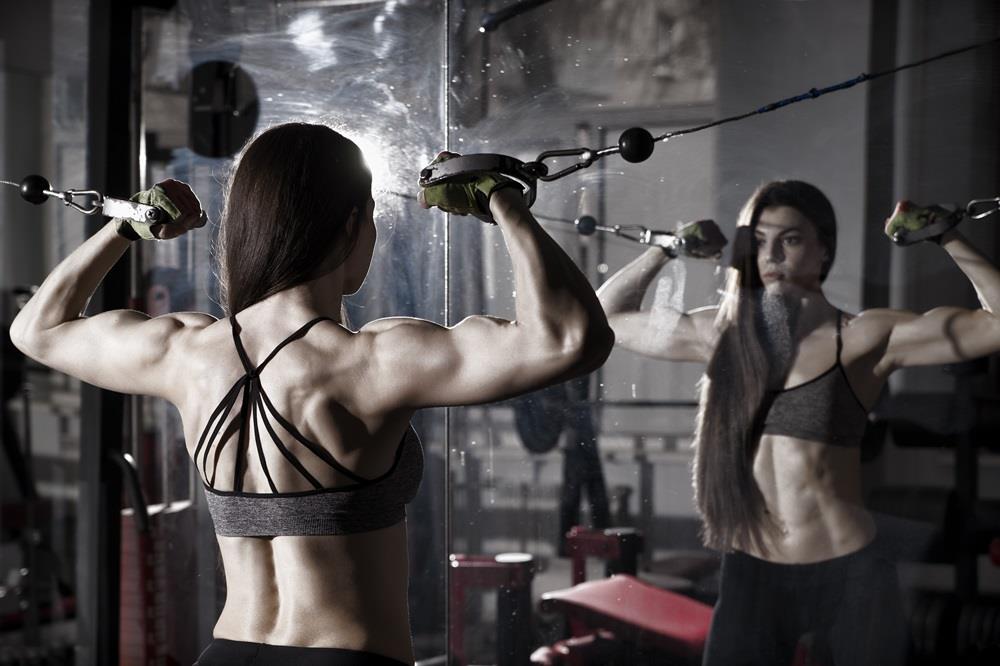 A woman with strong back doing back exercises